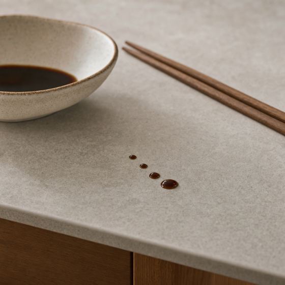 Soy sauce sitting in beads on top of the sintered stone surface