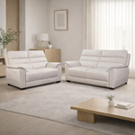White leather sofa set in a living room with a coffee table and decor.