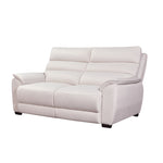 White sofa in a living room with wooden coffee table and side table.