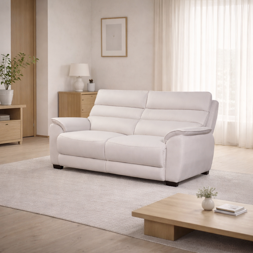 White sofa in a living room with wooden coffee table and side table.