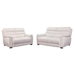 White sofa in a living room with wooden coffee table and side table.