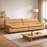 Beige sofa in a living room with a wooden coffee table and decor items.