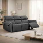 Gray reclining sofa in a living room setting with a wooden coffee table and decor items.