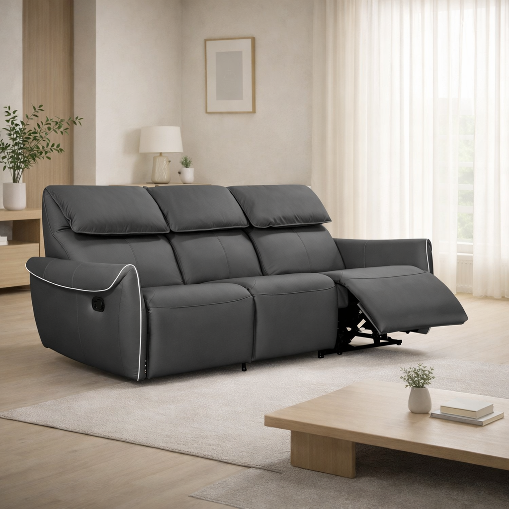 Gray reclining sofa in a living room setting with a wooden coffee table and decor items.
