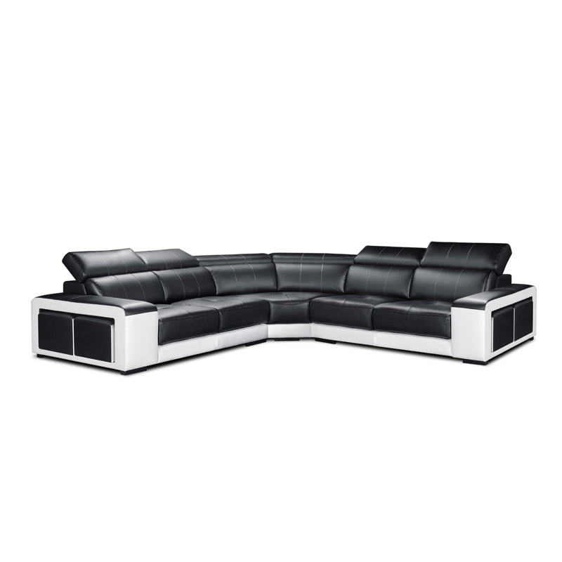 Black and white sectional sofa in a modern living room with a wooden coffee table and plant.