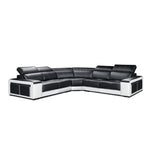 Black and white sectional sofa in a modern living room with a wooden coffee table and plant.